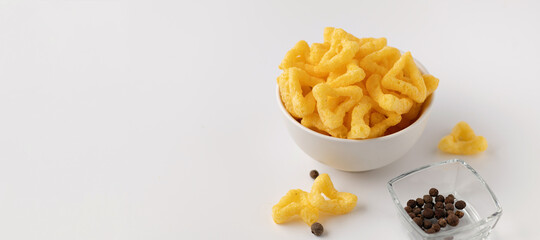 banner, cheese snacks in a ceramic bowl with black peppercorns, a snack for drinks, on a white background