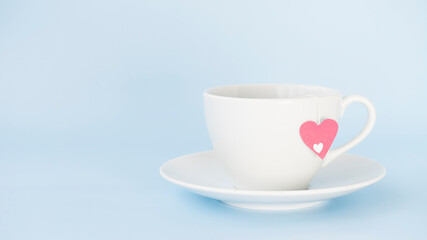 White tea pair with tea. There is a tea bag with a heart in the cup