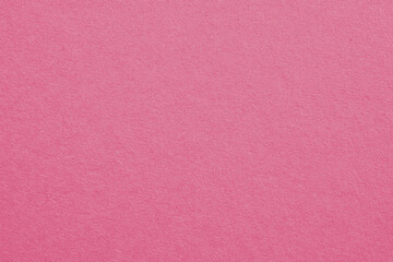 Pale red-violet cardboard surface. Paper texture with cellulose fibers. Light red background with a pastel tint. Paperboard wallpaper. Textured pacific pink backdrop. Macro