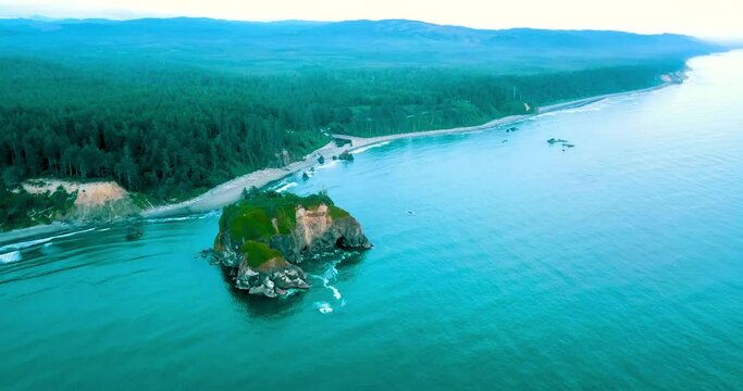 Aerial Scenic Shot Of Famous Ruby Beach, Drone Flying Backwards Over Sea Water