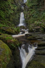 Fototapeta na wymiar Stunning long exposure landscape early Autumn image of Pistyll Rhaeader waterfall in Wales, the tallest waterfall in UK