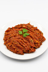 Chili paste on a white background. spicy paste. A kind of adjika. Turkish cuisine appetizers. Vertical view. Close up
