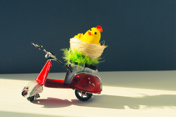 Chicken toys in a basket on a scooter.