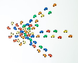 Car traffic jam from small toy cars in the form of an arrow isolated on a white background, top view.