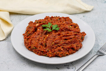Chili paste on a stone background. spicy paste. A kind of adjika. Turkish cuisine appetizers. Horizontal view. Close up
