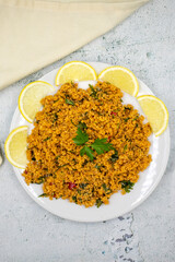 Bulgur salad (kisir) on a stone background. Traditional delicious food. Turkish cuisine appetizers. Top view. close up