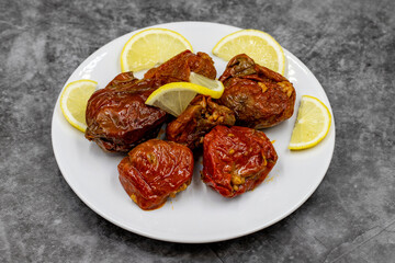 Dried stuffed peppers on a dark background. Rice stuffed sundried red pepper. Turkish cuisine appetizers. Kuru biber dolması. Horizontal view. close up