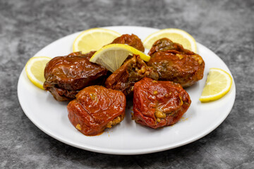 Dried stuffed peppers on a dark background. Rice stuffed sundried red pepper. Turkish cuisine appetizers. Kuru biber dolması. Horizontal view. close up