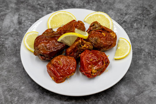 Dried stuffed peppers on a dark background. Rice stuffed sundried red pepper. Turkish cuisine appetizers. Kuru biber dolması. Horizontal view. close up