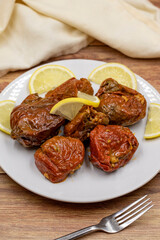 Dried stuffed peppers on a wooden background. Rice stuffed sundried red pepper. Turkish cuisine appetizers. Kuru biber dolması. Vertical view. close up