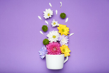 flowers in a cup on a purple background top view