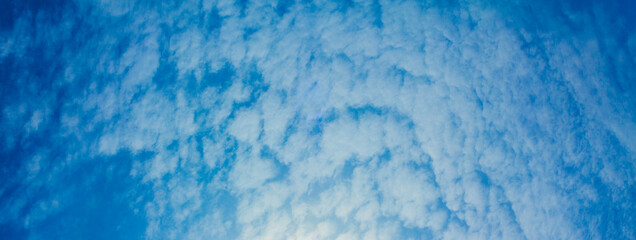 Blue sky with chemical clouds chemical sky chemtrails sunny day.