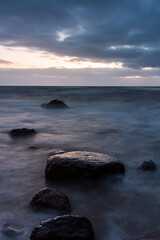 Fototapeta na wymiar Baltic Sea rocks and beach sand at sunset