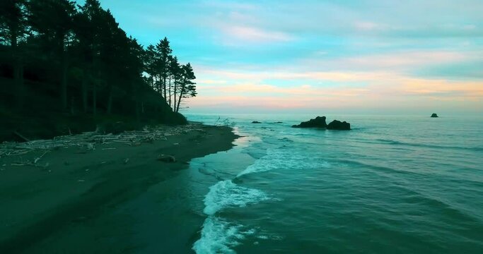 Aerial Panning Beautiful Shot Of Rock In Ocean, Drone Flying Forward During Sunset - Ruby Beach, Washington