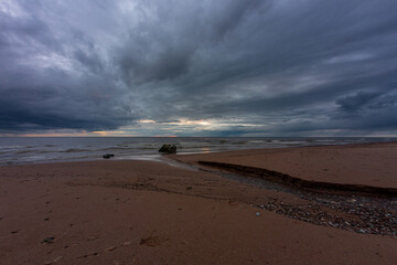 Baltic Sea rocks and beach sand at sunset