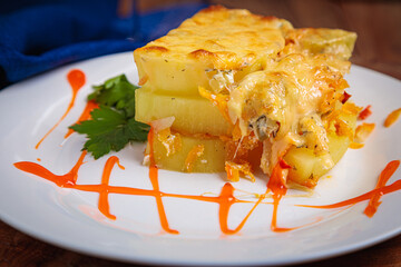 A serving of zucchini casserole is laid out on a white plate.