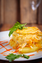 A serving of zucchini casserole is laid out on a white plate.