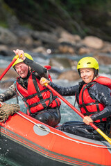 Two girls enjoying themself with river rafting water sports. Smiles, recreation and happiness...