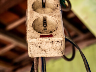 the socket is shabby and dirty hanging above
