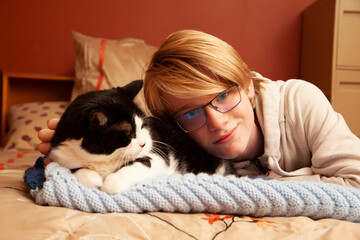 teenage boy and his pet cat /
