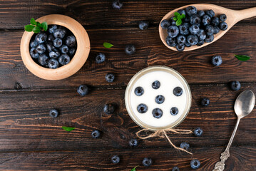 Healthy breakfast with yogurt and blueberry on  wooden table.
