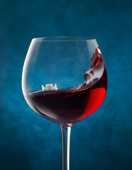 Paper steamboat floating in a glass of red wine