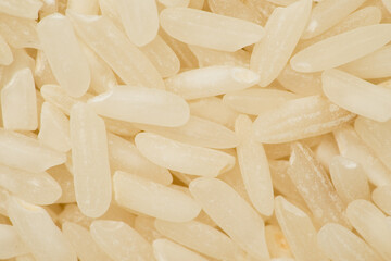 Fototapeta na wymiar Long grain rice background or texture. Macro, top view 
