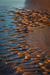 Baltic Sea rocks and beach sand at sunset