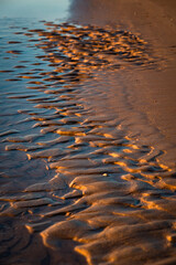 Baltic Sea rocks and beach sand at sunset