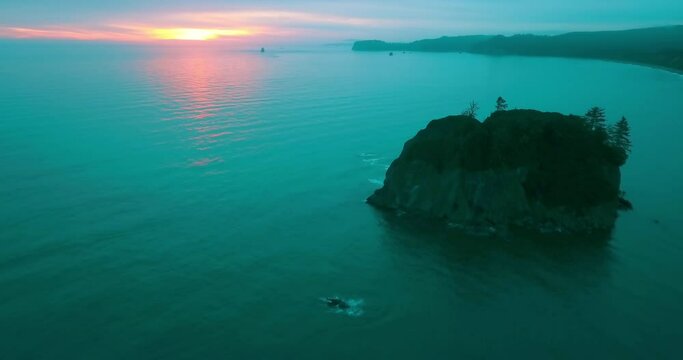 Aerial Panning Beautiful Shot Of Rock In Ocean During Sunset - Ruby Beach, Washington