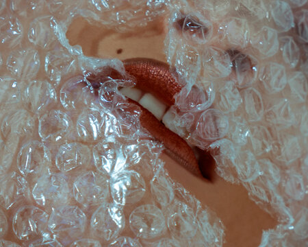 Female mouth and bubble wrap close up