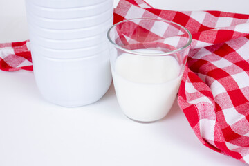 Bottle and glass of milk with a red picnkic checkered towel
