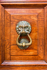 Ancient bronze door handle in the form of a head of a lion