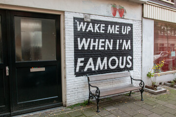 Fototapeta na wymiar Wake me up when I'm famous logo street painting in Amsterdam 