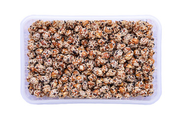 Plastic box of candied peanuts.