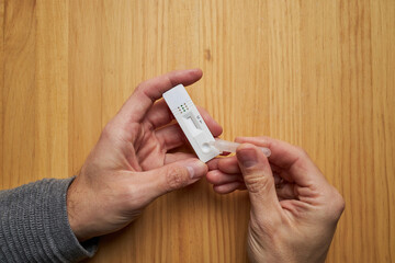 Anonymous person performing a COVID 19 rapid test