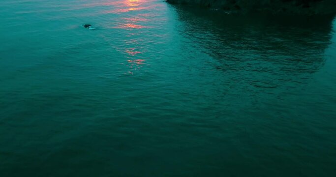 Aerial Backward Scenic Shot Of Rock In Ocean, Drone Ascending During Sunset - Ruby Beach, Washington