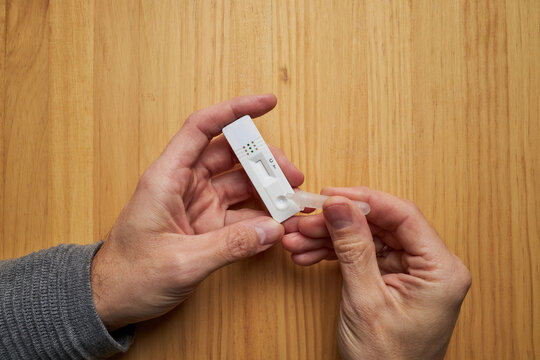 Anonymous person performing a COVID 19 rapid test