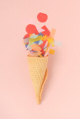 ice cream cone with colorful confetti in a pink background 