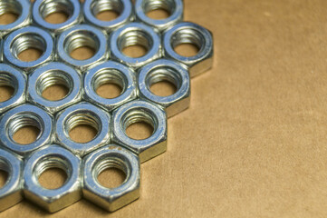 Metal nuts for bolts. Fasteners. Soft focus, copy space
