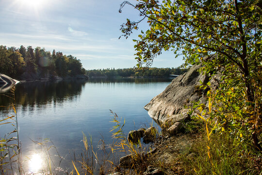 Quiet bay with sunny cliff and autumn colors