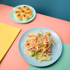 noodle and sushi rolls on a color background, minimalism