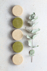 Eco friendly solid handmade colorful shampoo bars on light colored background.