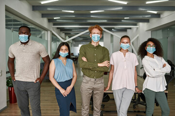 Obraz premium Group of multiracial business team in masks