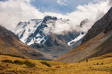 Trekking group of hikers in Karakol valley on trail to Ala Kul lake. Karakol valley, Issyk-kul...