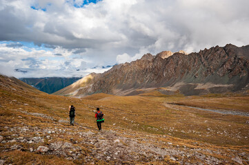 Trekking group of hikers in Karakol valley on trail to Ala Kul lake. Karakol valley, Issyk-kul...