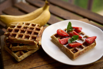 Waffles with strawberries, bananas and honey. High quality photo