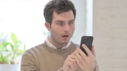 Portrait of Man Reacting to Loss on Smartphone