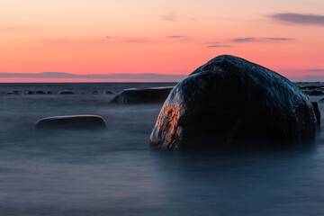 Baltic Sea rocks and beach sand at sunset