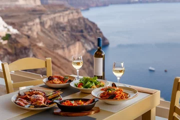 Poster Dinner for two in a restaurant overlooking the sea © Santorines